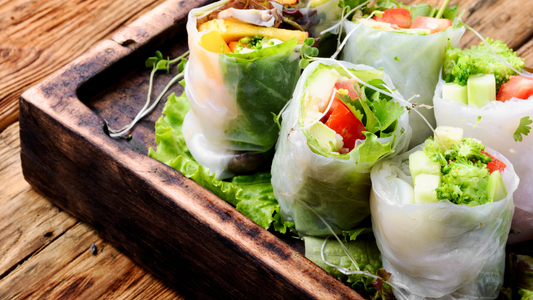 Assorted Asian spring rolls with fresh vegetables and healthy microgreens, a delicious vegetarian appetizer.